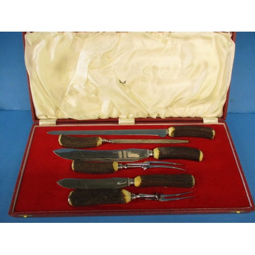 A 1982 boxed 6 piece antler handled carving set from Harrods in unused condition with original purchase receipt