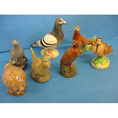 214 - A quantity of vintage Beswick figures, to include small whisky decanters, all in good condition with... 