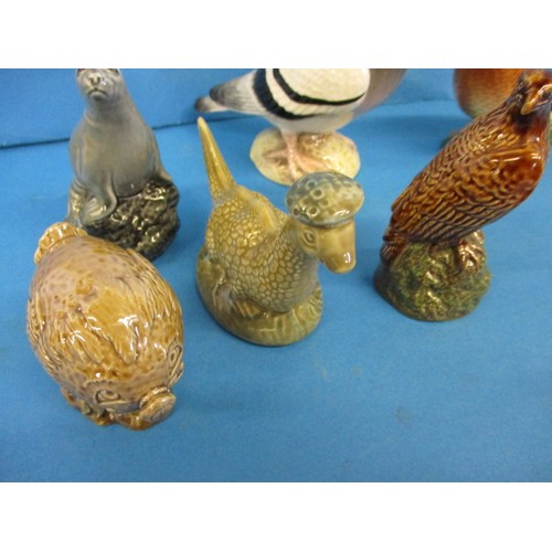 214 - A quantity of vintage Beswick figures, to include small whisky decanters, all in good condition with... 