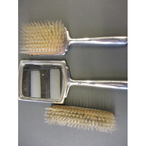 69 - A silver 3 piece dressing table set and an additional silver backed clothes brush, some minor dentin... 