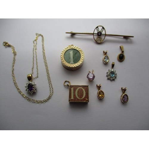 297 - A parcel of gold jewellery items to include bank note charms a necklace, bar brooch and pendants set... 