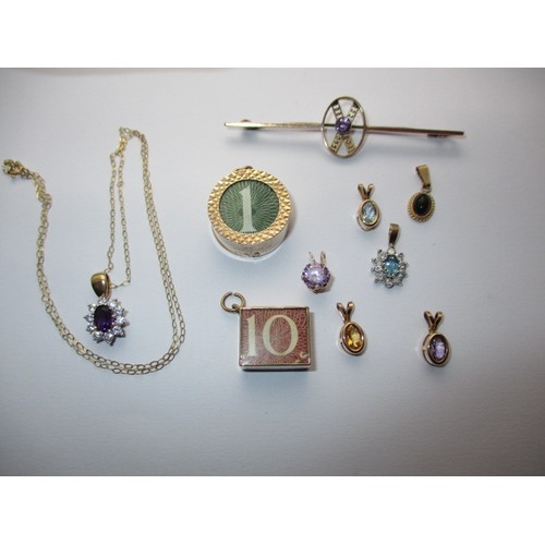 297 - A parcel of gold jewellery items to include bank note charms a necklace, bar brooch and pendants set... 