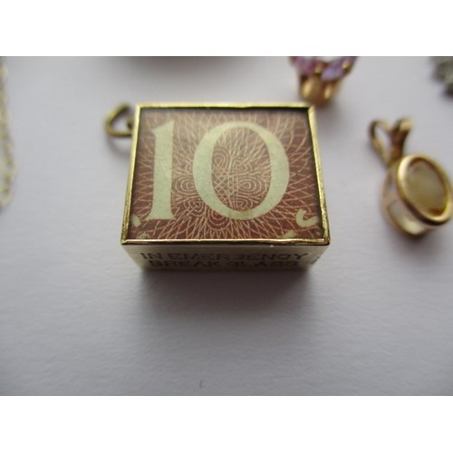 297 - A parcel of gold jewellery items to include bank note charms a necklace, bar brooch and pendants set... 