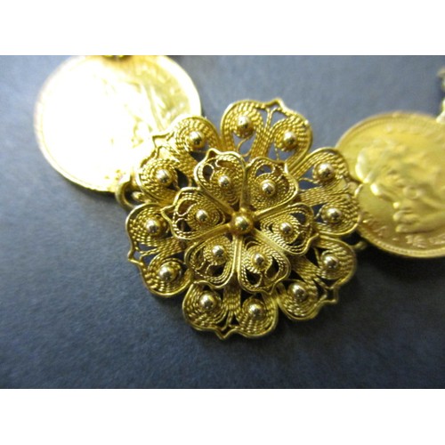 300 - A gold bracelet with filigree panels linking six Peruvian 1/5 Libra gold coins, approx. total weight... 