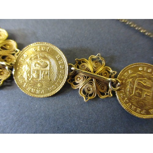 300 - A gold bracelet with filigree panels linking six Peruvian 1/5 Libra gold coins, approx. total weight... 