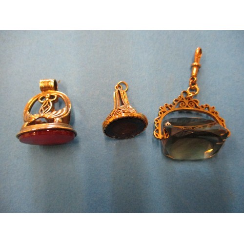 66 - Three 9ct gold mounted watch fobs, each with a different hard stone, in good used condition