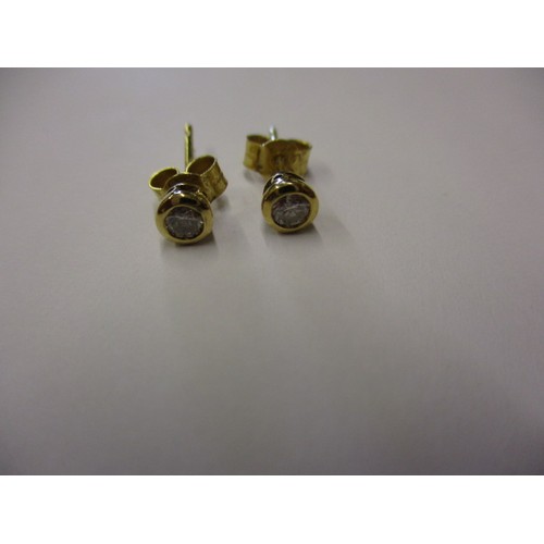 46 - A pair of 9ct yellow gold and diamond stud earrings, in pre-owned condition with minor general age r... 