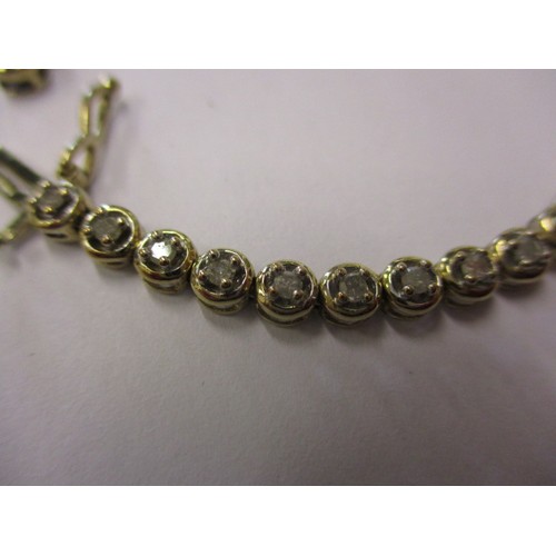 67 - A 9ct yellow gold and diamond tennis bracelet, in good condition with working clasp and general use ... 