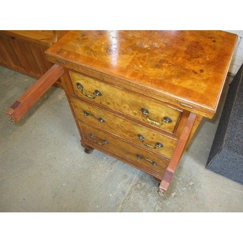 323 - A 20th century maple chest of 3 drawers with fold over table top resting on loapers, approx. dimensi... 