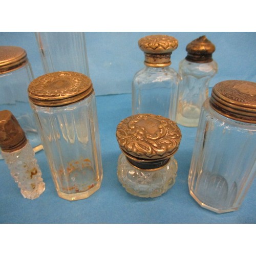 155 - A quantity of vintage silver mounted dressing table jars, in various conditions, some dented and all... 