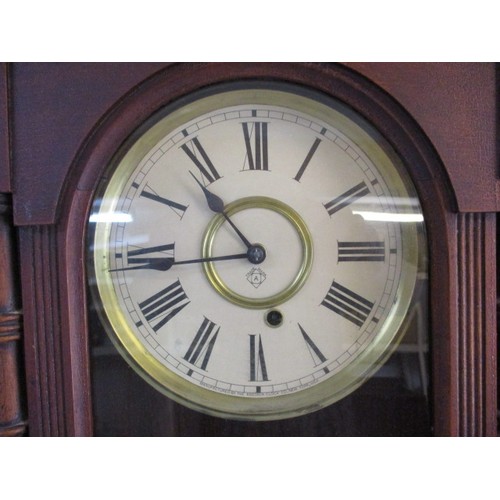 304 - A vintage wood cased wall clock with key and pendulum, runs when wound, approx. length 82cm, in good... 