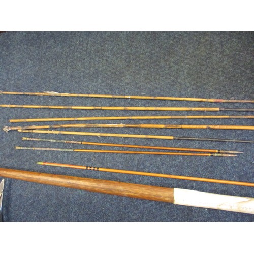 234 - A vintage English longbow and a North African metal and bone example and a collection of arrows, all... 