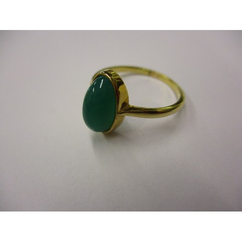 6 - An 18ct yellow gold ring set with a single green cabochon stone, approx. ring size P1/2, approx. wei... 