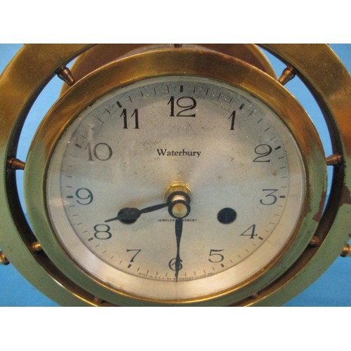 289 - A brass ships wheel clock, having had the movement converted to battery, approx. height 22cm