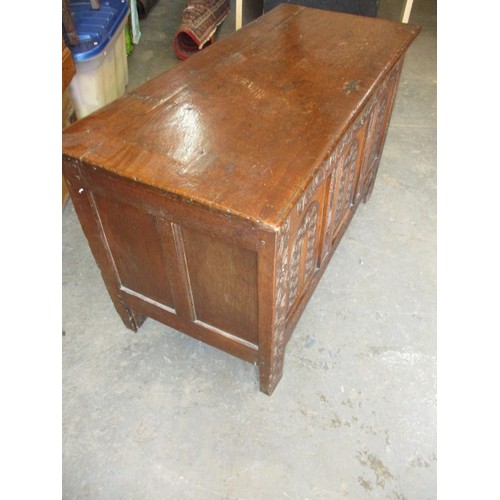 281 - An 18th century oak coffer, of panel construction on style legs and having carved decoration approx.... 