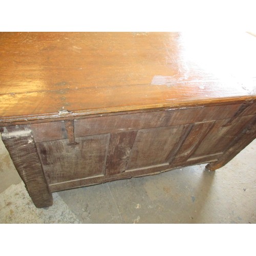 281 - An 18th century oak coffer, of panel construction on style legs and having carved decoration approx.... 