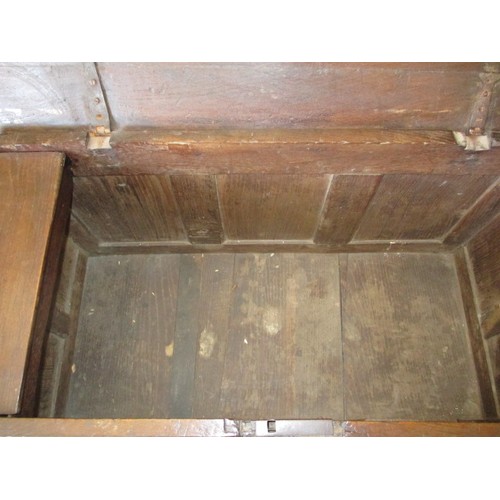 281 - An 18th century oak coffer, of panel construction on style legs and having carved decoration approx.... 