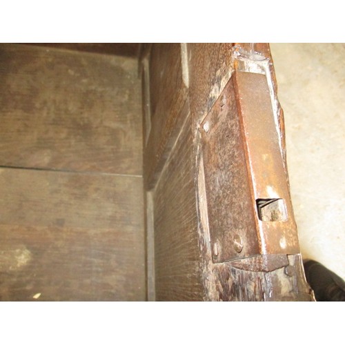 281 - An 18th century oak coffer, of panel construction on style legs and having carved decoration approx.... 