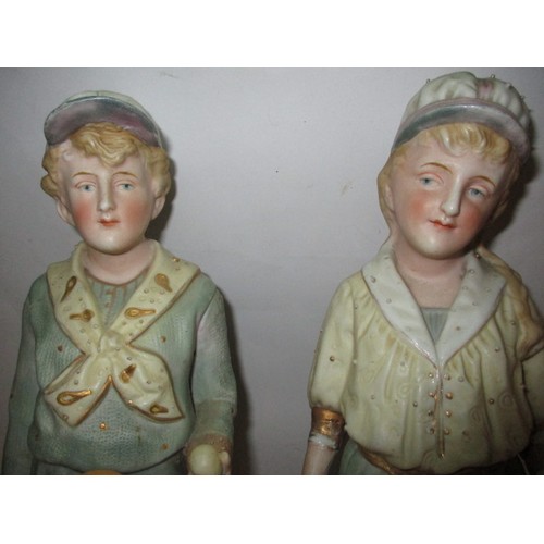 181 - Two late 19th century German Gebruder Huebach bisque porcelain tennis player figures, the girl havin... 