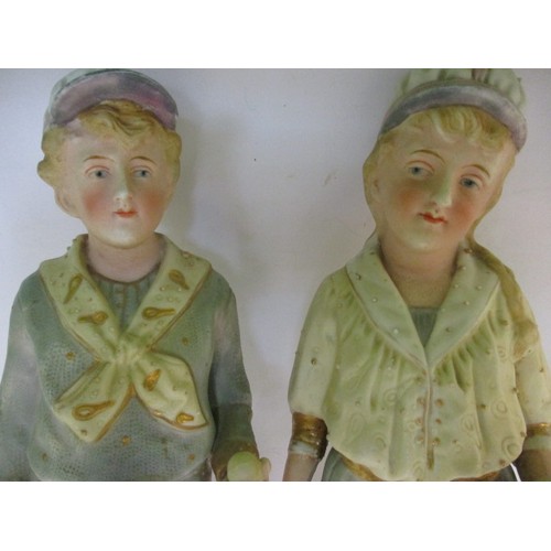 181 - Two late 19th century German Gebruder Huebach bisque porcelain tennis player figures, the girl havin... 