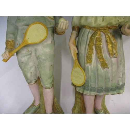 181 - Two late 19th century German Gebruder Huebach bisque porcelain tennis player figures, the girl havin... 