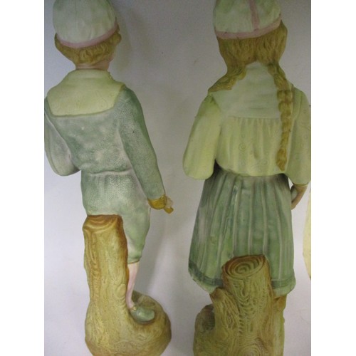 181 - Two late 19th century German Gebruder Huebach bisque porcelain tennis player figures, the girl havin... 