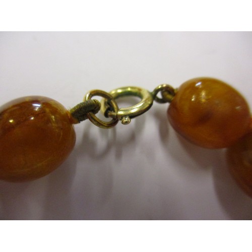 165 - A vintage Baltic amber necklace, with graduated beads and a yellow metal clasp. Approximate linear l... 