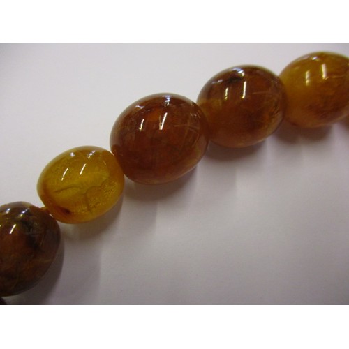 165 - A vintage Baltic amber necklace, with graduated beads and a yellow metal clasp. Approximate linear l... 