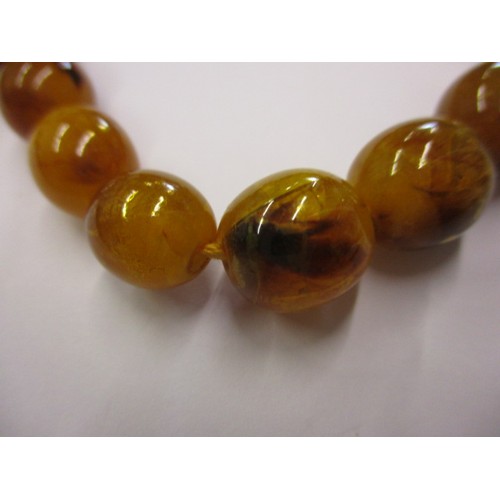 165 - A vintage Baltic amber necklace, with graduated beads and a yellow metal clasp. Approximate linear l... 