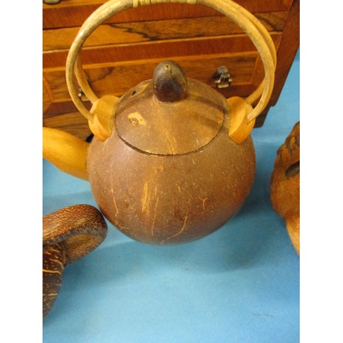 370 - 2 vintage coconut teapots and a nut mask, with two other treen items.