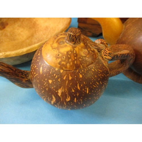 370 - 2 vintage coconut teapots and a nut mask, with two other treen items.