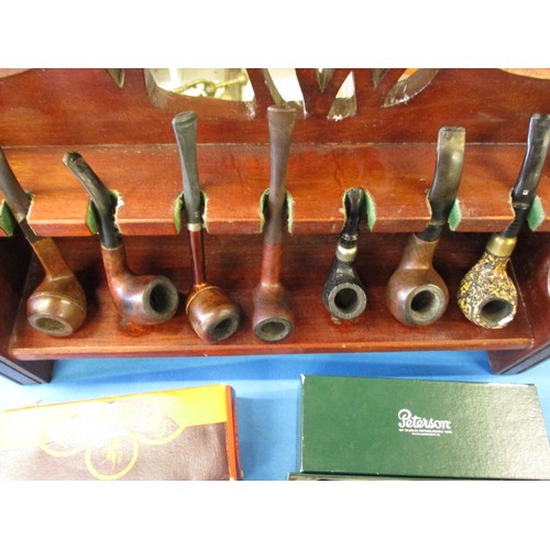 254 - A quantity of vintage pipes and display rack, to include examples by K & P Peterson of Dublin. All i... 