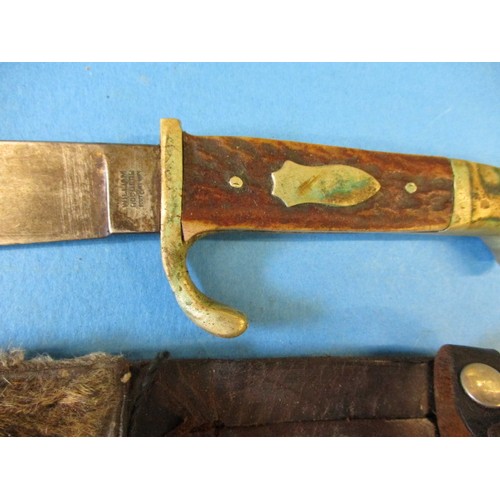 223 - A WWII German police? dagger in scabbard and a William Rodgers hunting knife, both in pre-owned cond... 