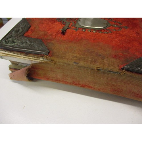 198 - A Victorian photo album with various 19th century and later photos, having ware to spine and edges a... 