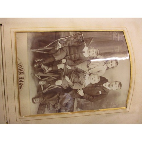 198 - A Victorian photo album with various 19th century and later photos, having ware to spine and edges a... 