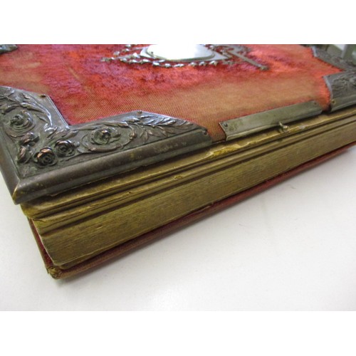 198 - A Victorian photo album with various 19th century and later photos, having ware to spine and edges a... 