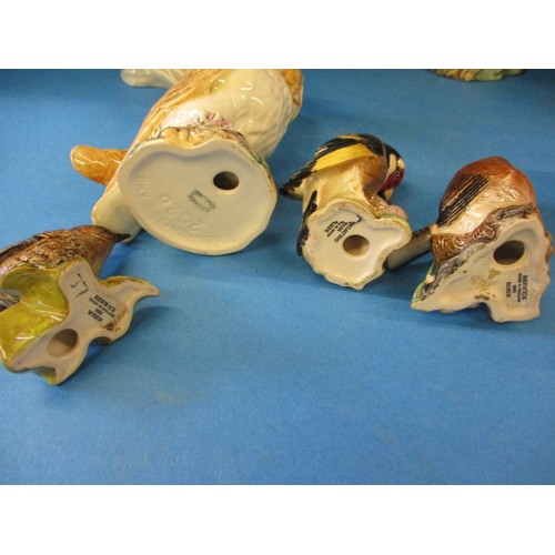 202 - A parcel of vintage Beswick bird models, to include several owls, one having what looks like a facto... 