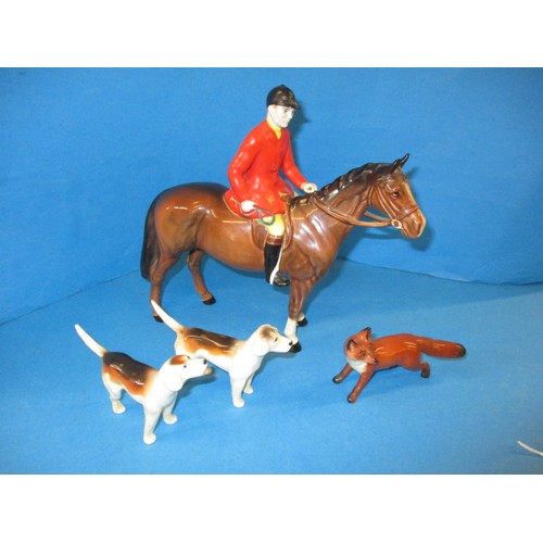 203 - A vintage Beswick 1501 huntsman on horse, 2 hounds and a fox.  The left front hoof shows signs of be... 