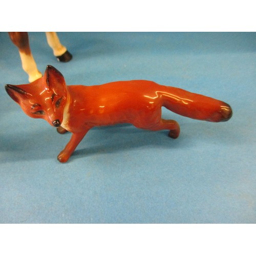 203 - A vintage Beswick 1501 huntsman on horse, 2 hounds and a fox.  The left front hoof shows signs of be... 