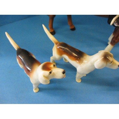 203 - A vintage Beswick 1501 huntsman on horse, 2 hounds and a fox.  The left front hoof shows signs of be... 