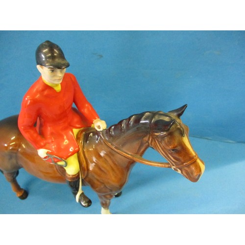 203 - A vintage Beswick 1501 huntsman on horse, 2 hounds and a fox.  The left front hoof shows signs of be... 