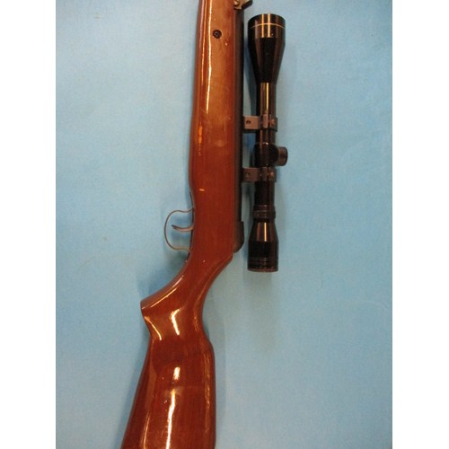 239 - A vintage break barrel .22 air rifle with 4x40 scope, in working order with general use related mark... 