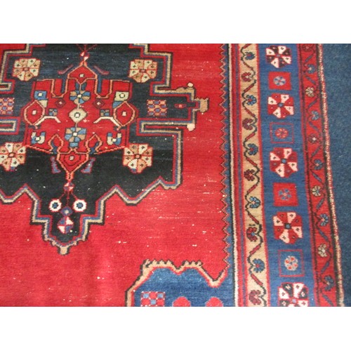 339 - A vintage Persian wool rug, approx. size 150cm x 200cm in used condition and retaining good colour w... 