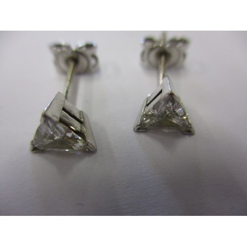 63 - A pair of vintage triangular diamond earrings, un-marked but believed to be on platinum, both in goo... 