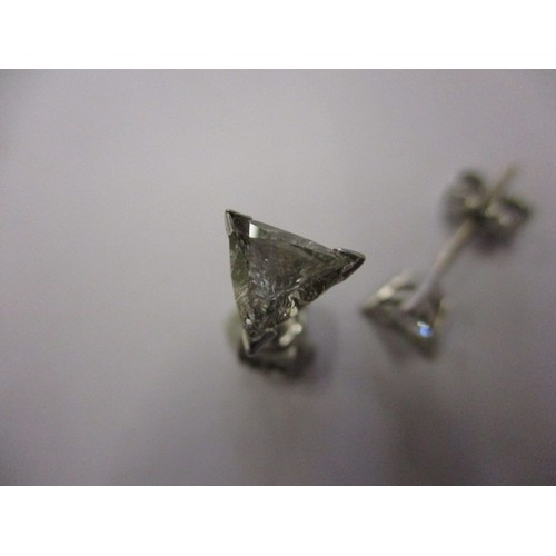 63 - A pair of vintage triangular diamond earrings, un-marked but believed to be on platinum, both in goo... 