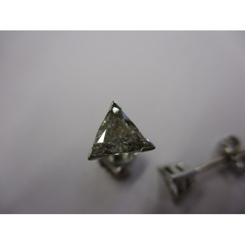 63 - A pair of vintage triangular diamond earrings, un-marked but believed to be on platinum, both in goo... 