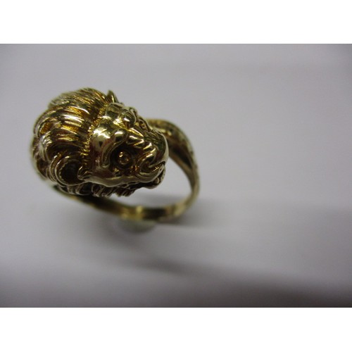 22 - An 18k yellow gold coil ring in the form of a serpent with a lions head, approx. ring size ‘R’ appro... 