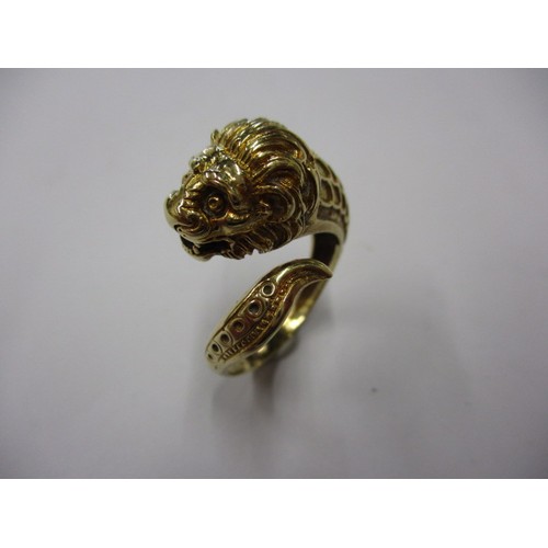 22 - An 18k yellow gold coil ring in the form of a serpent with a lions head, approx. ring size ‘R’ appro... 