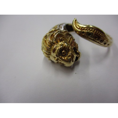 22 - An 18k yellow gold coil ring in the form of a serpent with a lions head, approx. ring size ‘R’ appro... 