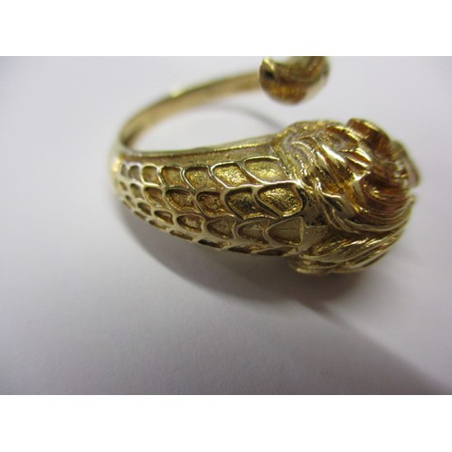 22 - An 18k yellow gold coil ring in the form of a serpent with a lions head, approx. ring size ‘R’ appro... 